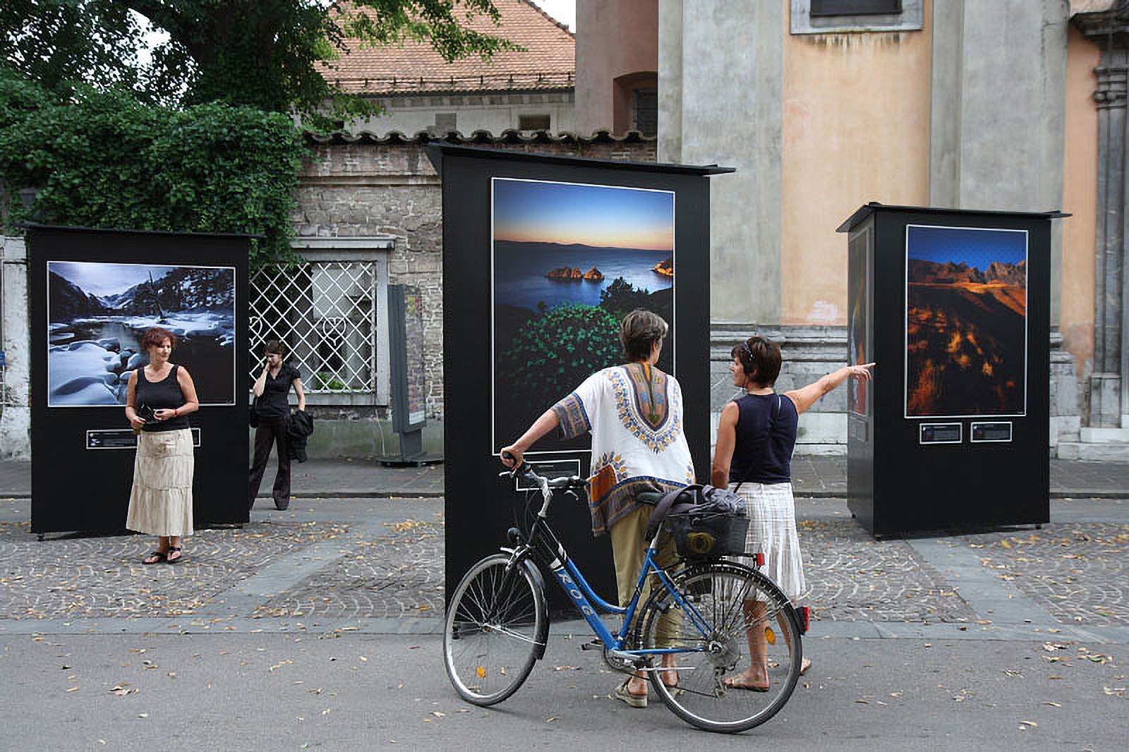 Visitors viewing Patrick Desgraupes landscapes at the Ljubljana open-air exhibition